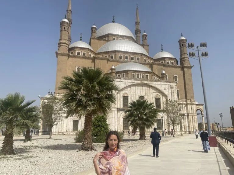Karen standing in front of a mosque building visited Egypt during Ramadan.