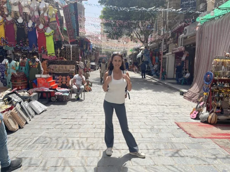 Karen standing in a street with many items on the ground in Khan El Khalili Egypt