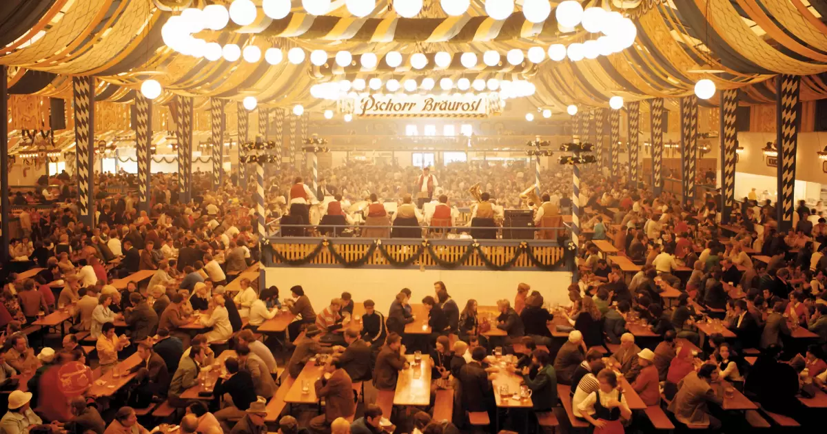 a large crowd of people sitting at tables in a large room
