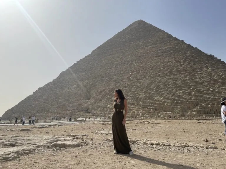 Karen in a long dress in front of pyramid Giza in Egypt.