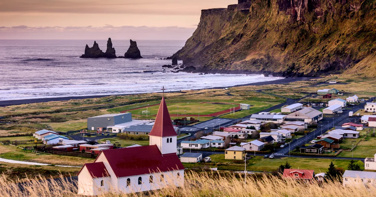 A small town of Vik in South Iceland sits on a hill overlooking the ocean.